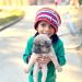 Portrait of a Small Boy in Knit Hat Holding a Puppy